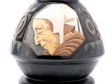 a black vase with a picture of a man and a woman on it