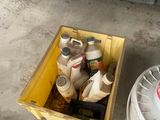 a yellow box filled with bottles and cans next to a white trash can