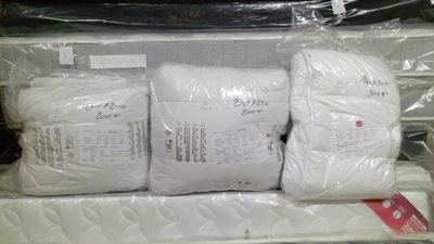 three pillows and a pillow on the top of a mattress