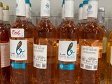 several bottles of wine are lined up on a shelf