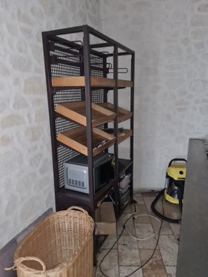 a room with a shelf and a basket on the floor