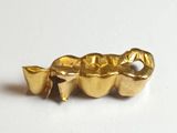 a gold plated tooth with a toothbrush in it