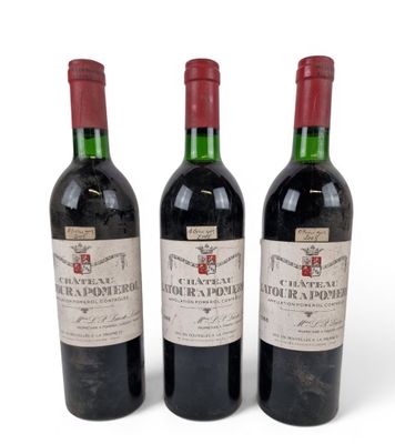 three bottles of red wine sitting next to each other on a white surface