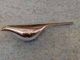 a bird shaped object sitting on the ground
