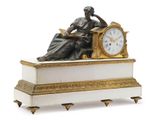 a statue of a woman sitting on top of a clock
