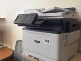 a printer sitting on top of a desk next to a computer