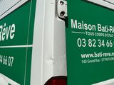 a green and white van parked in a parking lot