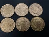 six different british coins, one of which has a coat of arms and the other of which has a crown