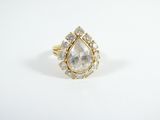 an image of a gold ring with a pear shaped diamond
