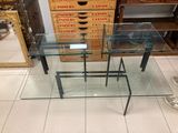 a glass table with a stack of boxes on top of it