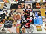 a table covered with many different types of vinyl records