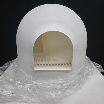 a white oven sitting on a table covered in plastic