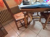 a table with a chair and a table cloth on top of it