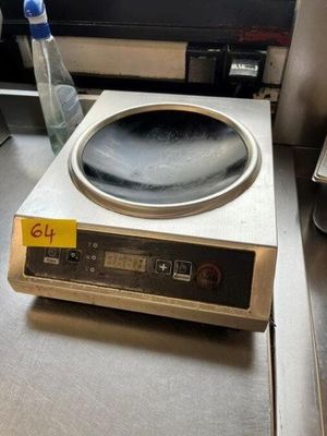 an image of a stove top with a bottle of water next to it