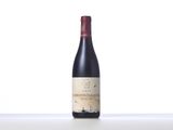 a bottle of red wine sitting on top of a table