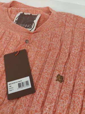 a close up of a sweater with a tag on it