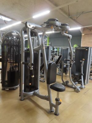a gym room with machines and other equipment in it