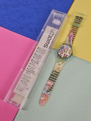 a watch sitting on top of a piece of paper