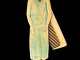 a picture of a woman in a dress and a comb