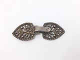 an image of a pair of antique silver earrings on a white surface