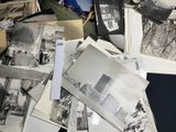 several old black and white photos of people and buildings on a table