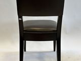 the back of a black leather chair with a black seat