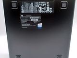 the back of a black laptop with a battery on top of it