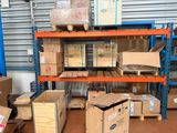 many boxes and boxes stacked on a shelf in a warehouse