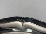 a close up of a silver plate on a table