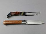 two knives that are sitting next to each other on a table