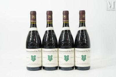 four bottles of wine are lined up on a white surface
