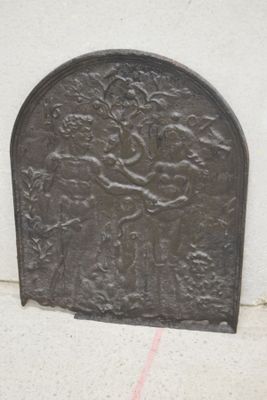 a metal door with a design on it on the sidewalk