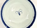 a blue and white bowl with a heart on it
