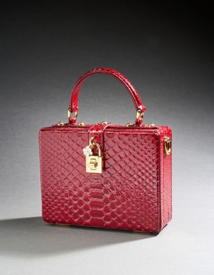 a close up of a red handbag with a lock on it