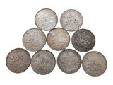 a pile of silver coins sitting on top of each other