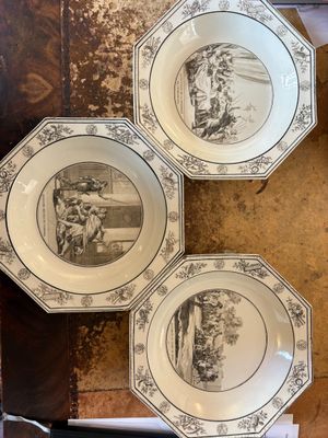 three plates with a picture of a man and a woman on them