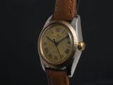 a close up of a wrist watch with roman numerals