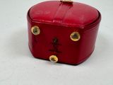 a small red box with gold studs on it