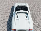 an aerial view of a white sports car parked on a brick road