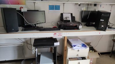 a desk with a lot of computer equipment on top of it