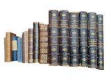 several old books stacked on top of each other on a white surface