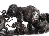 statue of a herd of elephants with a baby elephant and a baby elephant