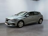 a grey car is parked in a large room with a white wall