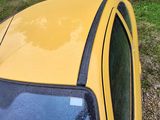 a yellow car that is parked on the side of the road