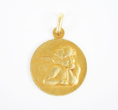 a close up of a gold coin with a small angel on it