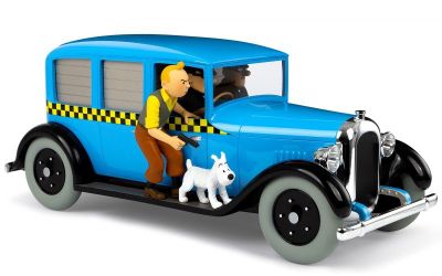 a blue toy car with a man and a dog in it