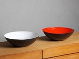 two bowls sitting on top of a dresser next to each other