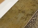 a metal box with a design on it sitting on a table