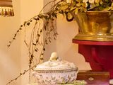 une table sur laquelle sont posés un vase de fleurs et une lampe