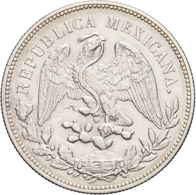 a close up of a coin with a bird on top of it